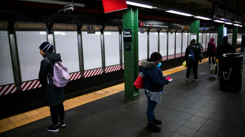 People wait at The Metropolitan Transportation Authority (MTA) subway system, for the train during the morning rush, during the outbreak of the coronavirus disease (COVID-19) in New York City, New York