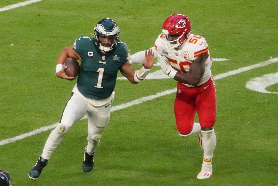 Philadelphia Eagles quarterback Jalen Hurts (1) runs the ball against Kansas City Chiefs linebacker Willie Gay (50) in the first half in Super Bowl LVII at State Farm Stadium in Glendale on Feb. 12, 2023.