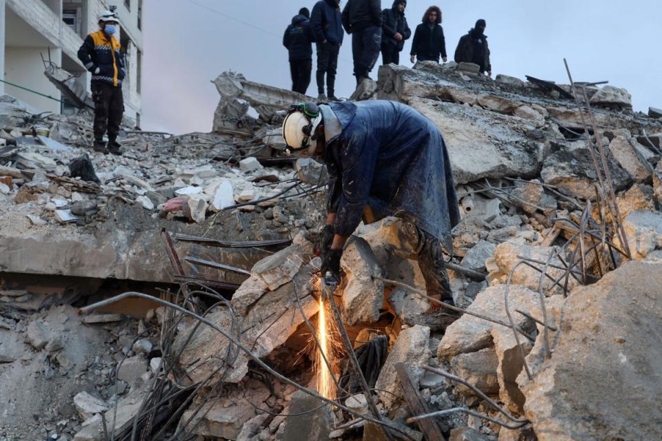 Members of the Syrian civil defence, known as the White Helmets look for casualties under the rubble following an earthquake in the town of Zardana in the countryside of the northwestern Syrian Idlib province, (AFP via Getty Images)