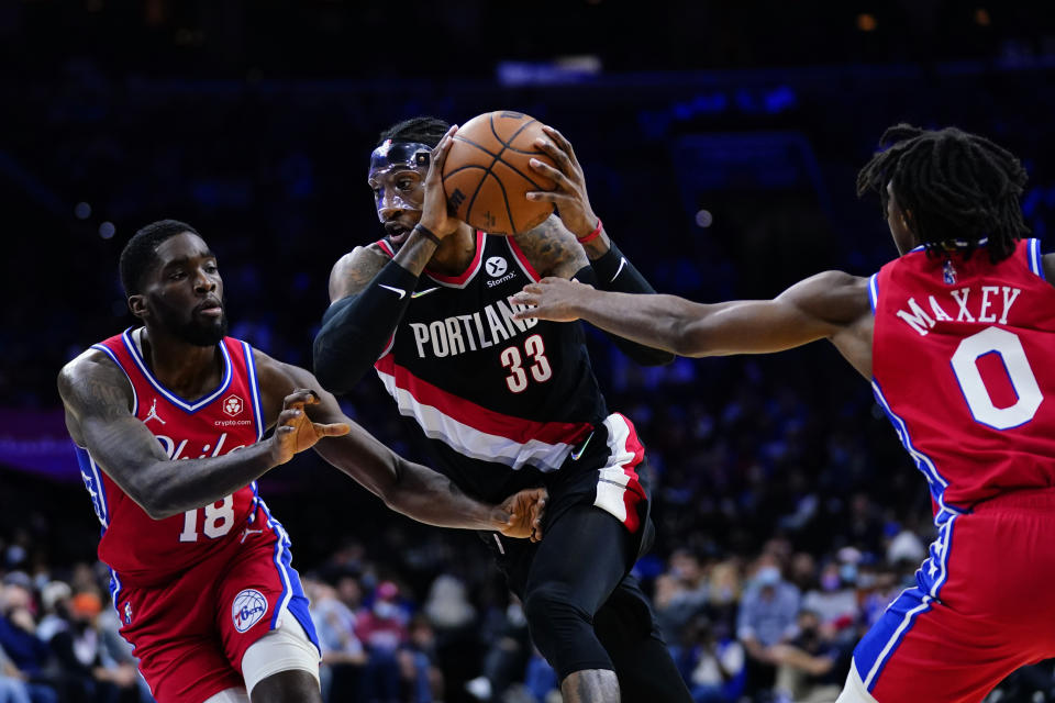 Portland Trail Blazers' Robert Covington (33) tries to get past Philadelphia 76ers' Shake Milton (18) and Tyrese Maxey (0) during the first half of an NBA basketball game, Monday, Nov. 1, 2021, in Philadelphia. (AP Photo/Matt Slocum)