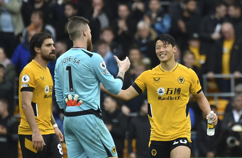 Wolverhampton Wanderers' Hwang Hee-chan, right, celebrates with Wolverhampton Wanderers' goalkeeper Jose Sa and Wolverhampton Wanderers' Ruben Neves after the English Premier League soccer match between Wolverhampton Wanderers and Newcastle United at Molineux stadium in Wolverhampton, England, Saturday, Oct. 2, 2021. (AP Photo/Rui Vieira)