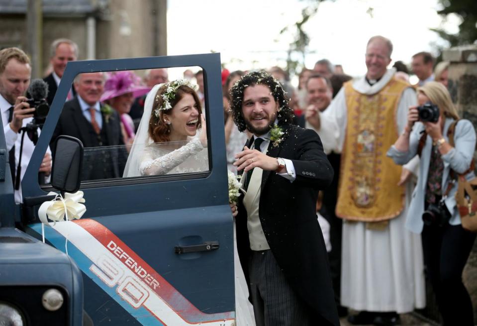 The newly married couple left in a Land Rover Defender (PA)