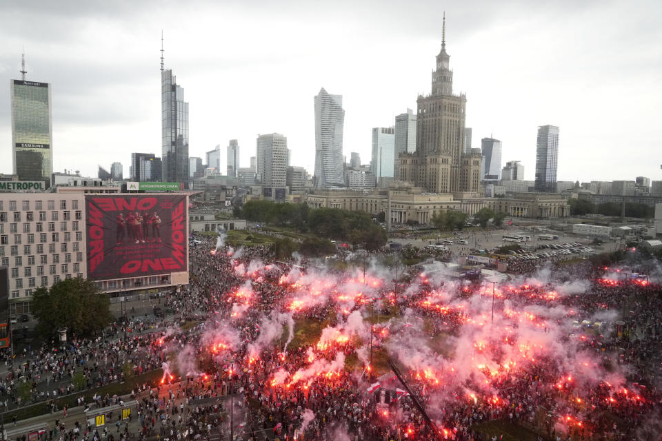 People light flares in Poland's capital as the country marks the 79th anniversary of the start of the Warsaw Uprising, a doomed revolt against the occupying Germans during World War II, in Warsaw, Poland, Tuesday, Aug. 1, 2023. (AP Photo/Czarek Sokolowski)