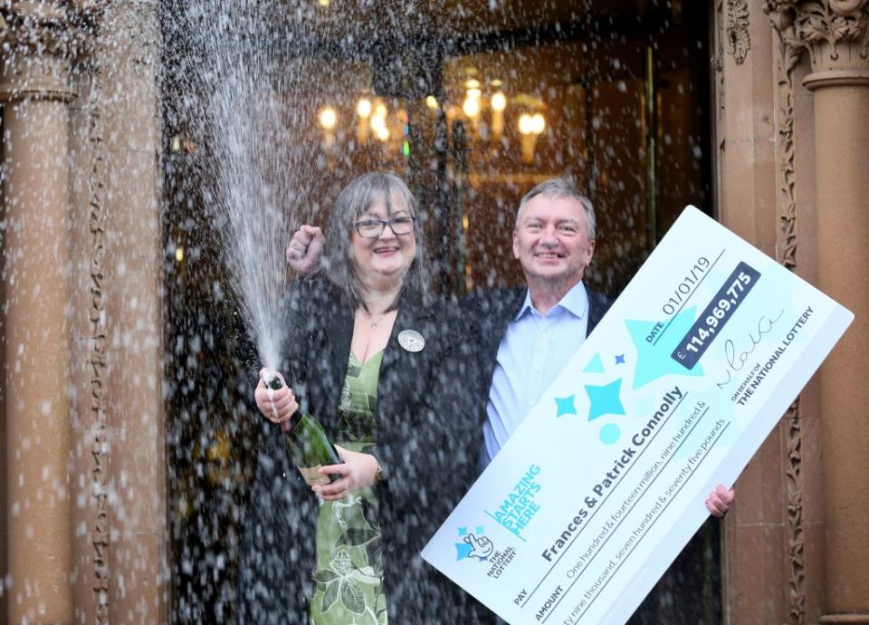 EuroMillions lottery winners, Frances (L) and Patrick Connolly pose during a photocall at the Culloden Hotel near Belfast, on January 4, 2019, after they were unveiled as the winners of the the New Year’s day EuroMillions lottery draw. (Photo credit PAUL FAITH/AFP/Getty Images)