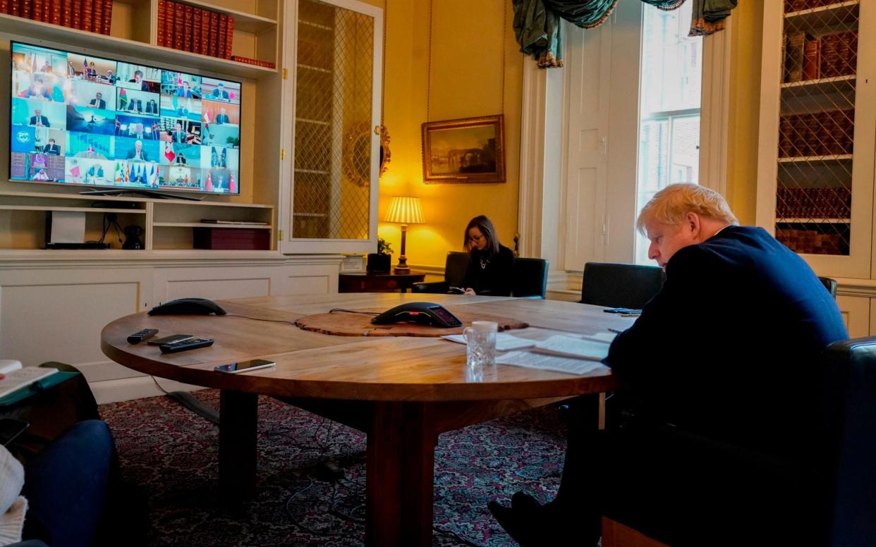 Boris Johnson participating in a video conference call with other G20 leaders in the study of 10 Downing Street in central London on March 26, 2020.  - ANDREW PARSONS /AFP