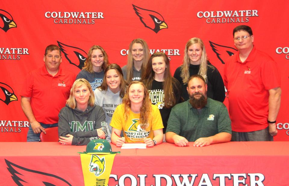 Coldwater senior Jillian McKinley, surrounded by family, friends and coaches, recently signed her letter of intent to swim at Northern Michigan University