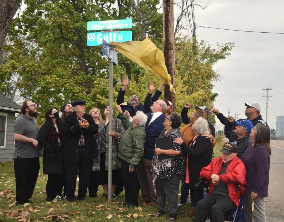Adrian city officials and members of the Ben and Connie Negron family unveil the new street sign along Gulf and East Beecher streets on Adrian's east side that now recognizes Gulf Street as honorary Cesar Chavez Drive, named for the late civil rights and labor movement activist.