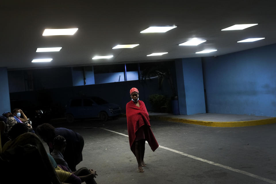 A pregnant woman waits to be attended to outside the Nuestra Senora de la Altagracia Maternity Hospital, in Santo Domingo, Dominican Republic, Tuesday, Nov. 23, 2021. Haitian officials and activists say the government is violating laws and agreements by deporting pregnant women, separating children from parents and arresting people between 6 p.m. and 6 a.m. as President Luis Abinader has unleashed a flurry of anti-Haitian actions. (AP Photo/Matias Delacroix)