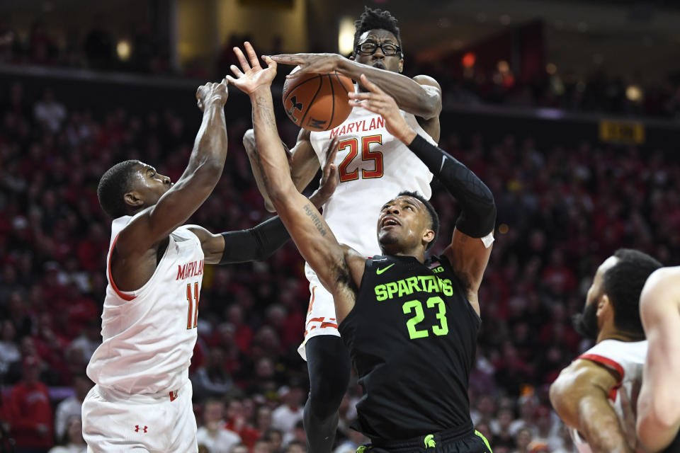 Michigan State forward Xavier Tillman Sr. (23) has his shot blocked by Maryland forward Jalen Smith (25) during the first half of an NCAA college basketball game Saturday, Feb. 29, 2020, in College Park, Md. (AP Photo/Terrance Williams)