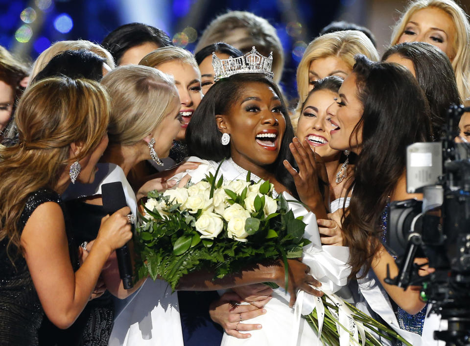 FILE - This Sept. 9, 2018 file photo shows Miss New York Nia Franklin, center, reacting after being named Miss America 2019 in Atlantic City, N.J. The Miss America Organization says this year's pageant will be held at the Mohegan Sun Connecticut in Uncasville, Connecticut. It will be broadcast on NBC Dec. 19, in a switch from recent broadcaster ABC. (AP Photo/Noah K. Murray, File)