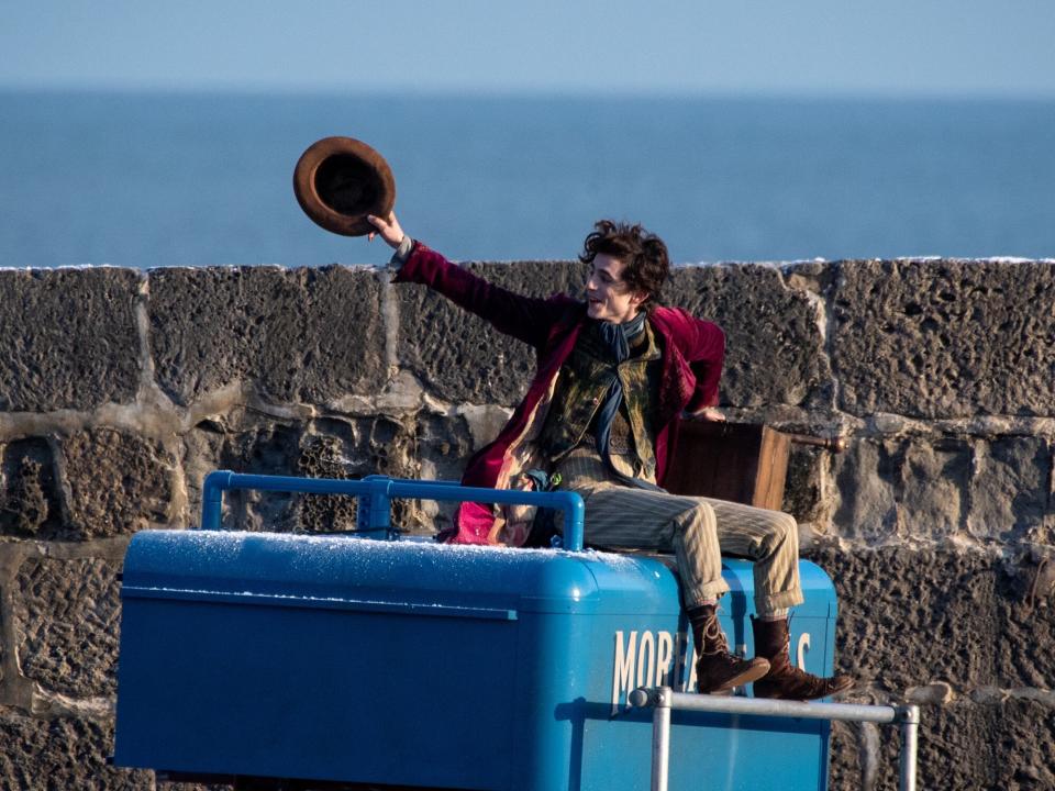 Timothée Chalamet is seen as Willy Wonka leaving the ship on the top of a van during filming for the Warner Bros and the Roald Dahl Story Company's upcoming movie 'Wonka' on October 12, 2021, in Lyme Regis, England