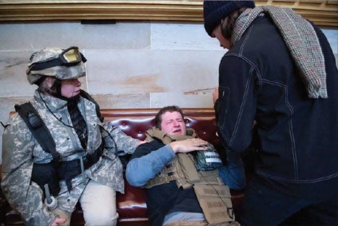 A photo from the criminal complaint against the Parkers shows Sandra, left, sitting inside the Capitol Building wearing tactical gear.