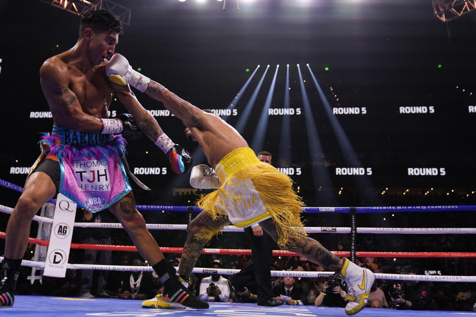 Gervonta Davis, right, hits Mario Barrios during the WBA Super Lightweight world championship boxing match on Saturday, June 26, 2021, in Atlanta. Davis won. (AP Photo/Brynn Anderson)