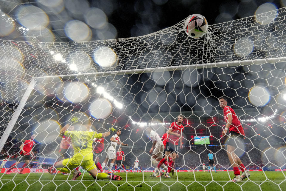 Austria's goalkeeper Patrick Pentz, left, fails to save a shot on goal by Turkey's Merih Demiral during a round of sixteen match between Austria and Turkey at the Euro 2024 soccer tournament in Leipzig, Germany, Tuesday, July 2, 2024. (AP Photo/Andreea Alexandru)