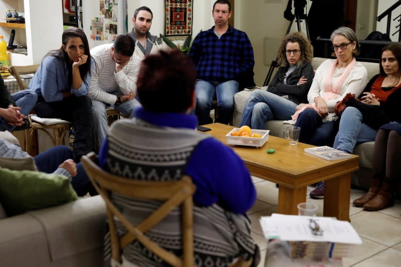 A group of guides from from Yad Vashem World Holocaust Remembrance Center listen to Holocaust survivor Vera Grossman Kriegel, 81, speak in Oranit, in the Israeli-occupied West Bank