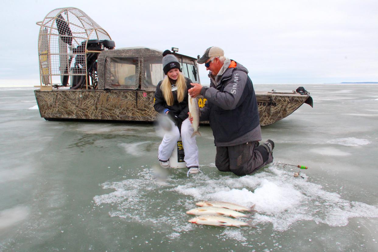 Bret Alexander and his daughter Portia fish for lake whitefish Jan. 28 on the ice of Green Bay. Alexander, a licensed fishing guide and owner of Alexander's Sport Fishing and Ice Fish Green Bay, recently purchased an airboat to help access fishing spots.