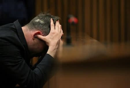 FILE PHOTO Paralympic gold medalist Oscar Pistorius reacts during the third day of the re-sentencing hearing for the 2013 murder of his girlfriend Reeva Steenkamp, at Pretoria High Court, South Africa June 15, 2016. REUTERS/Siphiwe Sibeko/File Photo