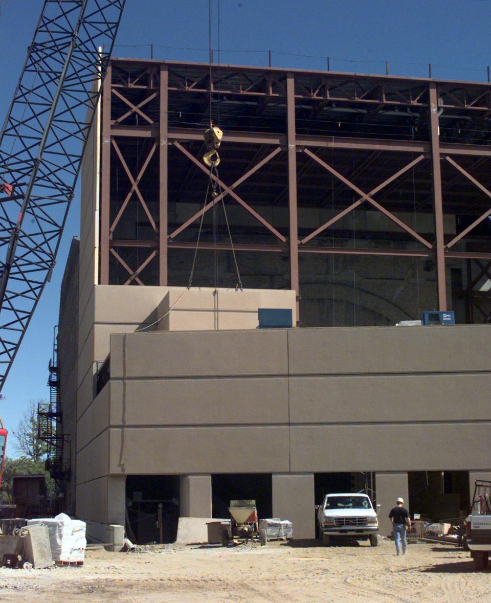 Workmen prepare to lift panels into place to make up the exterior walls of the Morris Civic Auditorium expansion currently under construction on Sept. 23, 1999.