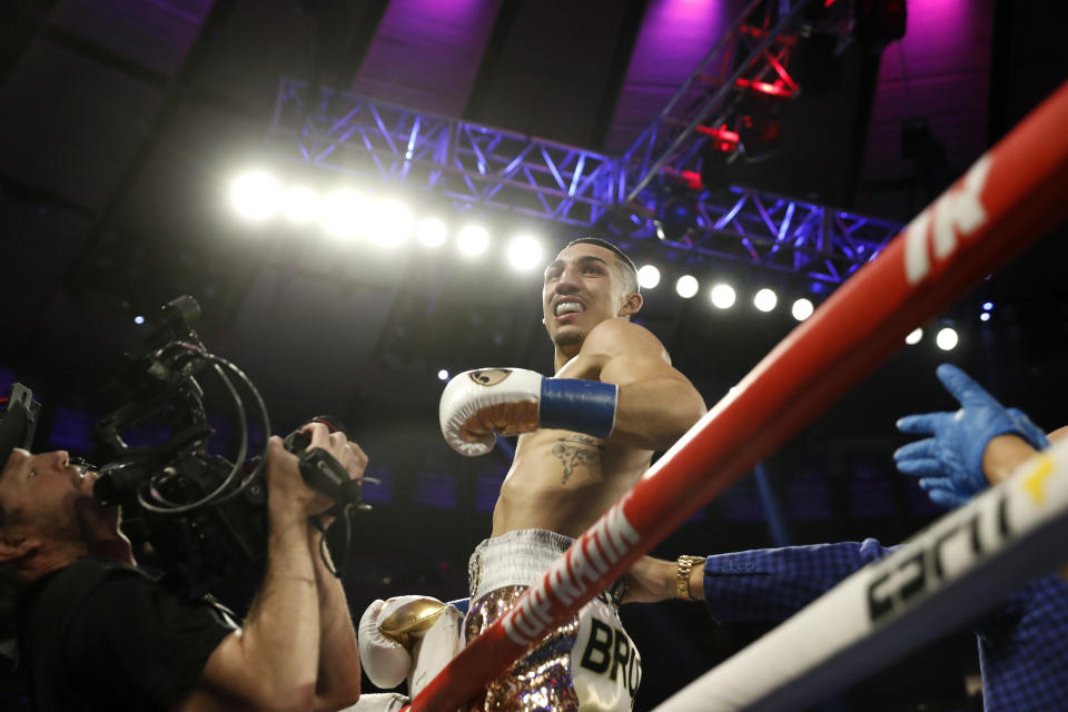 Teofimo Lopez, center, reacts after defeating Ghana's Richard Commey by TKO during the second round of an IBF lightweight boxing match, Saturday, Dec. 14, 2019, in New York. (AP Photo/Michael Owens)