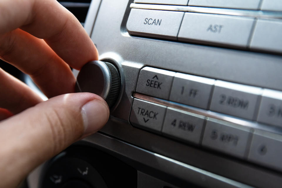 hand turning a knob in the car