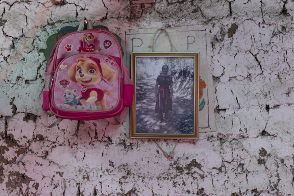 A portrait of Aracely Marroquín Coronado, who died in 2022 alongside 50 other migrants, asphyxiated in a smuggler's trailer truck in San Antonio, Texas, hangs inside a relatives' home in Comitancillo, Guatemala, Tuesday, March 19, 2024. The 21-year-old who had completed high school felt she had wasted her family’s money in studying since she still couldn’t get a professional job. (AP Photo/Moises Castillo)