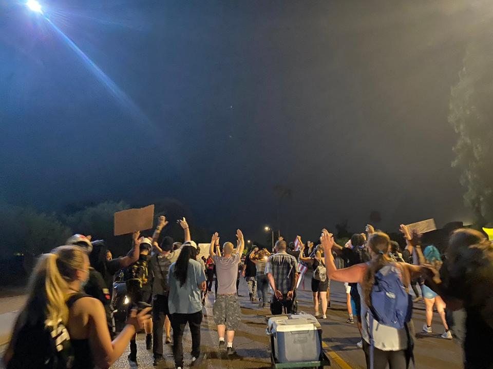 Protesters walk along Encanto Boulevard in Maryvale on July 5, 2020, during a protest for a man Phoenix police shot and killed on the Fourth of July.