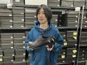 Ryosuke Matsui, the Japanese designer of the Godzilla shoes worn by the Oscar-winning team at the recent award ceremony, holds his design during an interview with The Associated Press at his company office on the outskirts of Tokyo, Friday, March 22, 2024. Matsui described his joy at seeing “Godzilla Minus One” director Takashi Yamazaki and his Shirogumi special-effects team walk the red carpet and win the visual effects Oscar, all while wearing his shoes. (AP Photo/Yuri Kageyama)
