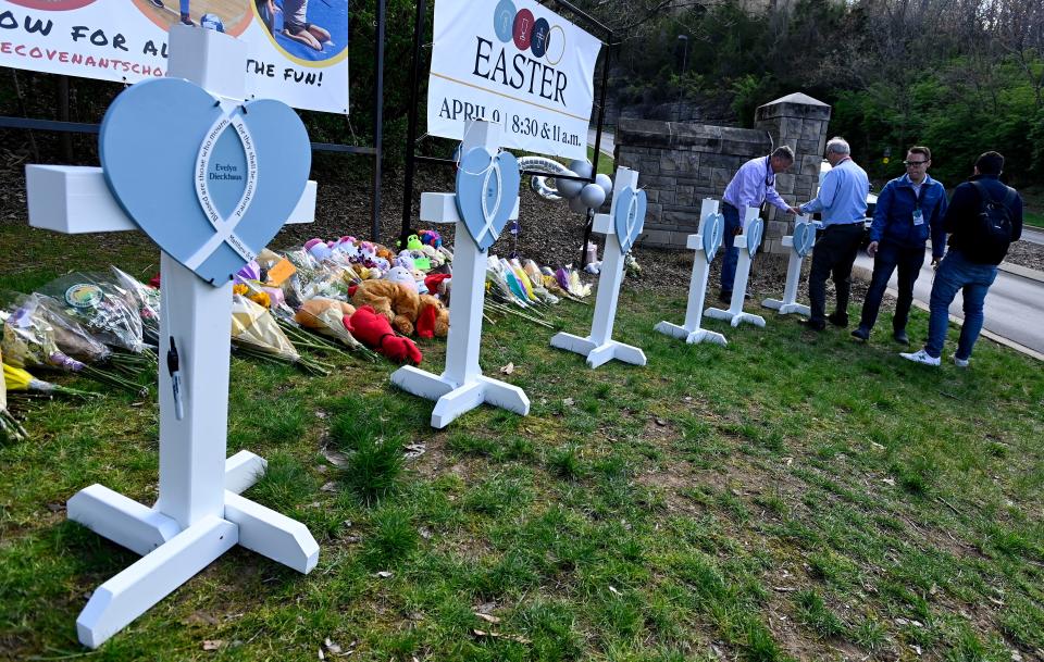 Members of the Lutheran Church Charities from Chicago, Illinois build wooden crosses at a makeshift memorial by the entrance of the Covenant School Tuesday, March 28, 2023, in Nashville, Tenn. Three children and three school staff members were killed by a former student in Monday’s mass shooting.