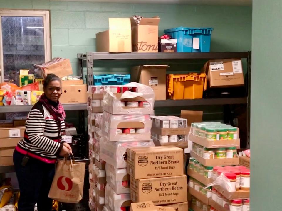 A'Jay Scipio, the program manager of the Northeast Food Emergency Program in Portland, Oregon, walks through the food pantry in mid-December as she helps clients look for special Christmas treats. "This is not a poor people problem," Scipio says of the estimated 700,000 people who could lose their SNAP benefits in the spring. "There are hard-working people, middle-class people, people with good jobs, who are hungry every day."