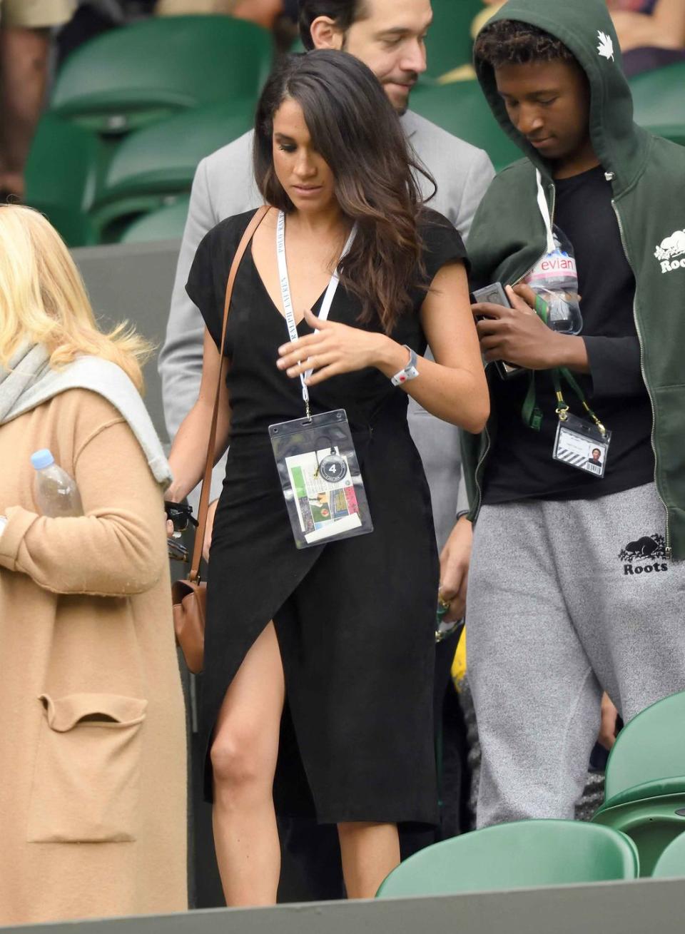 <p>For the Wimbledon Tennis Championships in London, Markle wears a black wrap dress.</p>