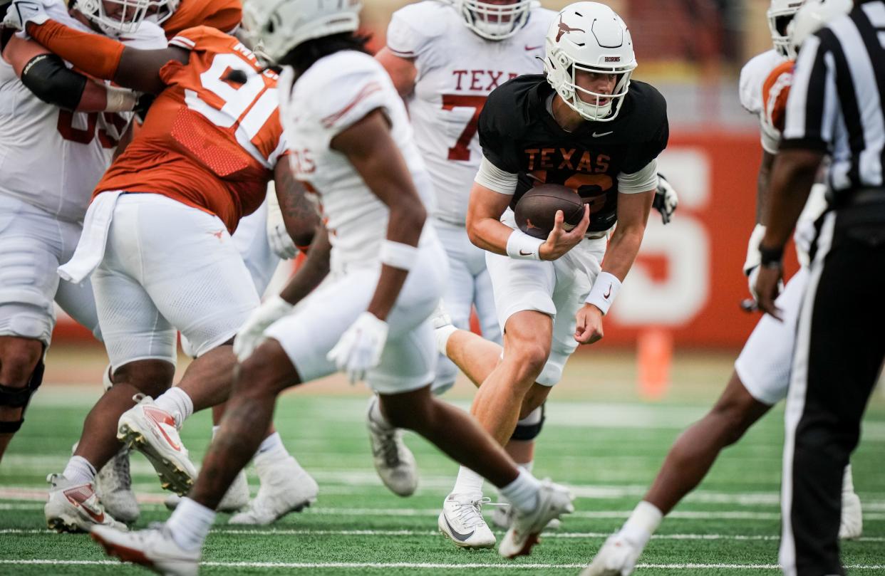 Texas quarterback Arch Manning takes off running in Saturday's Orange-White spring game at Royal-Memorial Stadium. While Manning dazzled in extended action, Longhorns starter Quinn Ewers stood on the sidelines for all but two brief series.