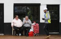 Women look at a construction worker in Bedworth, central England, April 1, 2015. REUTERS/Darren Staples