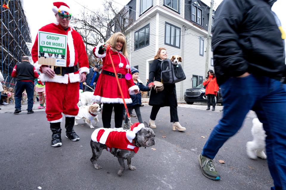 Susan Halley, of Wilmington, Ky., walks with her dog and her son, Dillon Davis, of Mount Adams, during the annual Reindog Parade in Mount Adams in 2022. This year's event takes place on Dec. 9.