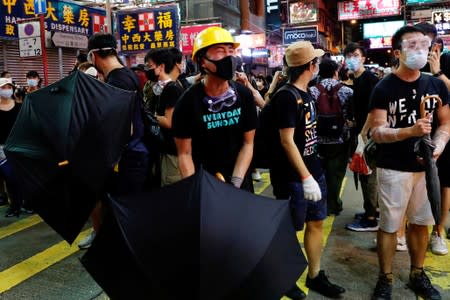 Anti-extradition bill protesters react after a conflict with riot police after a march at Hong Kong's tourism district Mongkok
