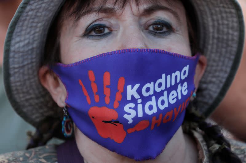 A demonstrator wearing a protective face mask takes part in a protest against femicide and domestic violence, in Istanbul