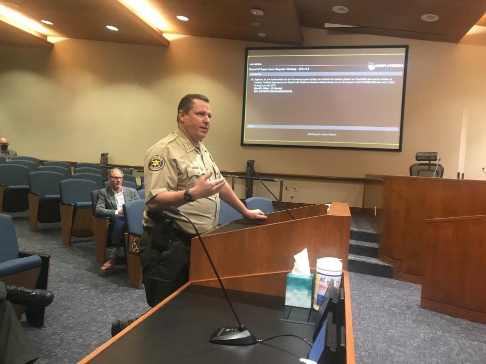 Assistant Sheriff Rob Davidson shares details about the contract with Wellpath with the Board of Supervisors on June 21. Wellpath President Kip Hallman is seated behind him.