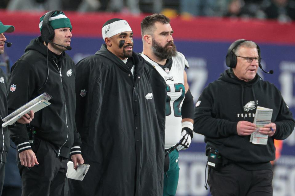 Philadelphia Eagles quarterback Jalen Hurts (center-left) and center Jason Kelce (62) look on during the second half against the New York Giants at MetLife Stadium.