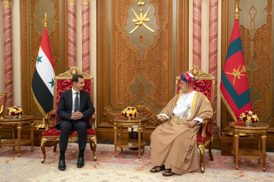 In this photo released by the official Syrian state news agency SANA, Omani Sultan Haitham bin Tariq, right, receives Syrian President Bashar Assad in the capital Muscat, Oman, Monday, Feb. 20, 2023. Assad visited the gulf nation of Oman Monday on his first official visit since the deadly Feb. 6 quake, his office said. (SANA via AP)