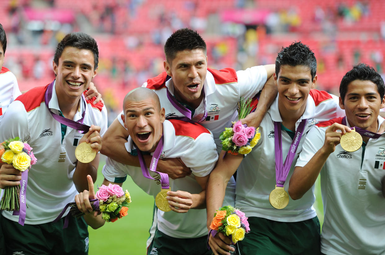 Left to right: Jose Rodriguez, Jorge Enriquez, Orobe Peralta, Raul Jimenez and Javier Aquino of Mexico celebrate winning the gold medal after victory during the Brazil vs. Mexico Final match in the Men's Soccer Competition as part of the 2012 London Olympic Summer Games at Wembley Stadium in London, UK on August 11th 2012. Photo: Visionhaus/Ben Radford (Photo by Ben Radford/Corbis via Getty Images)
