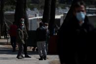 Migrants wearing protective face masks stand at the entrance of the Ritsona camp, after authorities found 20 coronavirus cases and placed the camp under quarantine, following the outbreak of coronavirus disease (COVID-19), in Ritsona