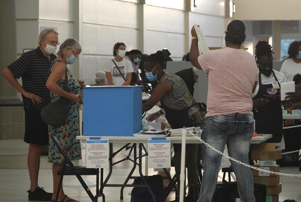 Voters line up as polls open, Tuesday, Aug. 18, 2020, at the Coral Ridge Mall in Fort Lauderdale, Fla. (Joe Cavaretta/South Florida Sun-Sentinel via AP)