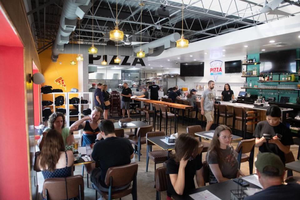 The main dining room at City Barrel Pizza + Patio includes bar seating, tables and booths.