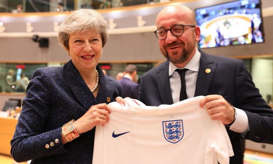 Theresa May and the Belgian prime minister hold up an England shirt at the recent EU summit