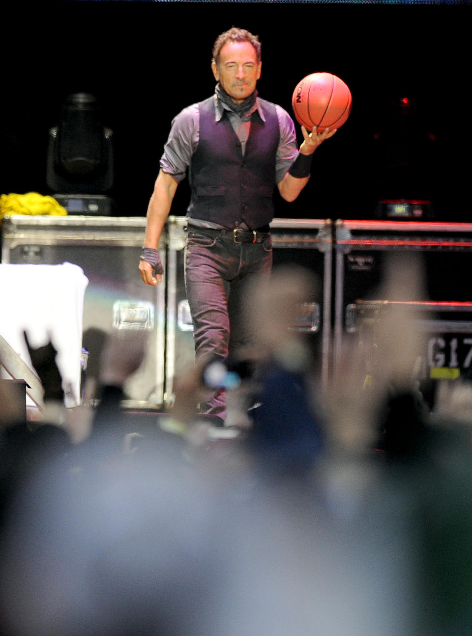 Bruce Springsteen walks onto the stage before performing with the E Street Band during the 2014 NCAA March Madness Music Festival - Capital One JamFest, Sunday, April 6, 2014, in Dallas. (Photo by Matt Strasen/Invision/AP)