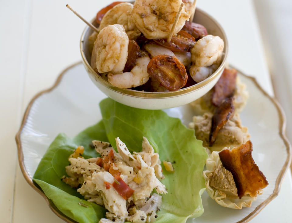 This Nov. 18, 2013 photo shows roasted shrimp cocktail, pinapple chicken lettuce wraps, and Elvis phyllo cups in Concord, N.H. (AP Photo/Matthew Mead)