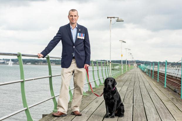 Charlie Threlfall and his dog on Hythe Pier.