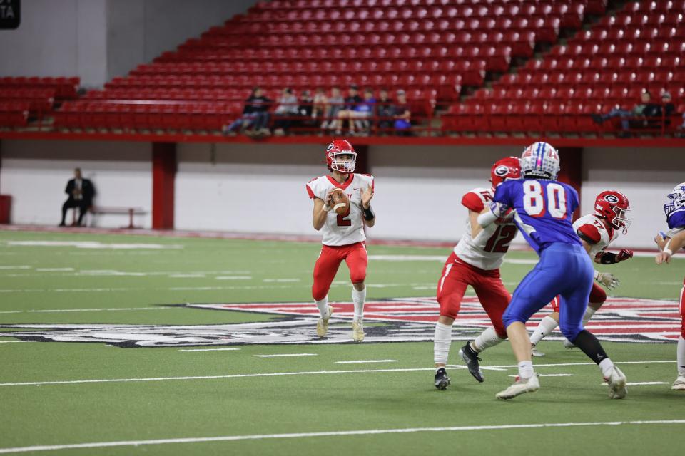 Gregory QB Rylan Peck (2) surveys down field during the SDHSAA 9A State Championship game Thursday November 10th, 2022 in Vermillion, SD.  Gregory won 36-23.