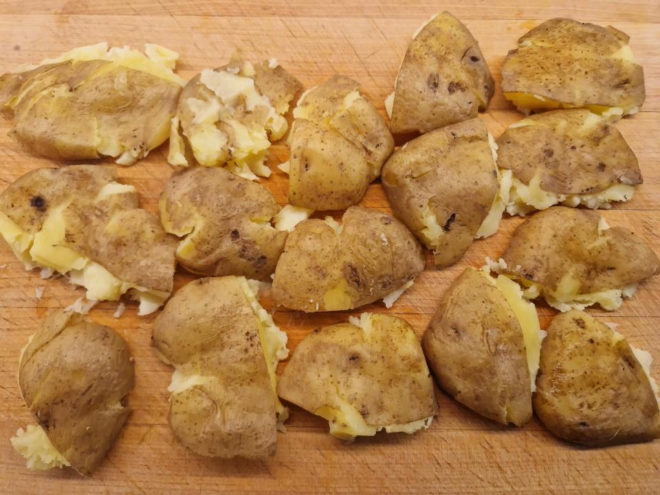 smashed potato wedges on a cutting board