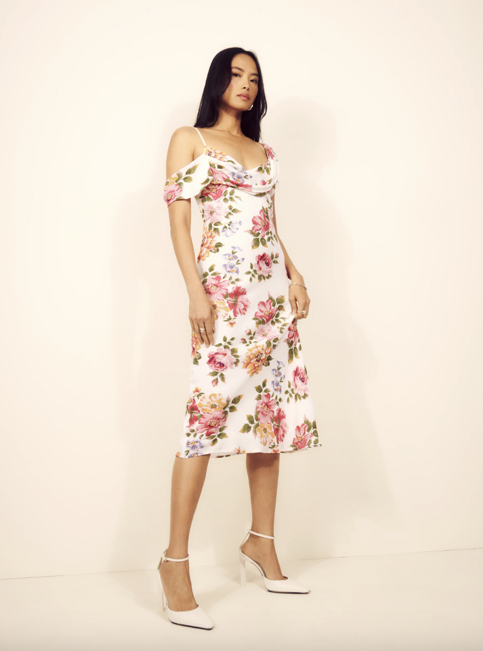 A model in a white and pink floral Reformation Reya dress (photo courtesy of Reformation)