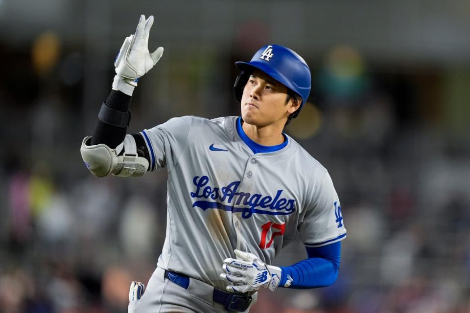 Shohei Ohtani signed a record-breaking, 10-year contract with the Los Angeles Dodgers in December 2023, for $700m (AP)